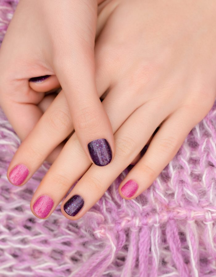 Pink nail design. Female hands with glitter manicure